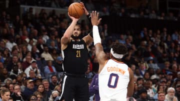 Nov 24, 2023; Memphis, Tennessee, USA; Memphis Grizzlies forward David Roddy (21) shoots as Phoenix Suns guard Jordan Goodwin (0) defends during the second half at FedExForum. Mandatory Credit: Petre Thomas-USA TODAY Sports