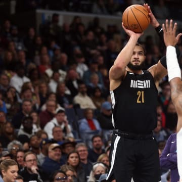 Nov 24, 2023; Memphis, Tennessee, USA; Memphis Grizzlies forward David Roddy (21) shoots as Phoenix Suns guard Jordan Goodwin (0) defends during the second half at FedExForum. Mandatory Credit: Petre Thomas-USA TODAY Sports