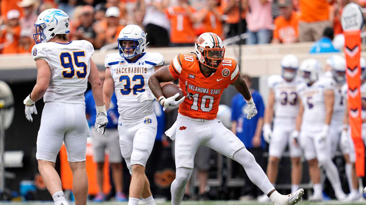 Oklahoma State's Rashod Owens (10) celebrates a play next to South Dakota State's Zac Wilson (95) and Adam Bock (32) in the first half of the college football game between the Oklahoma State Cowboys and South Dakota State Jackrabbits at Boone Pickens Stadium in Stillwater, Okla., Saturday, Aug., 31, 2024.