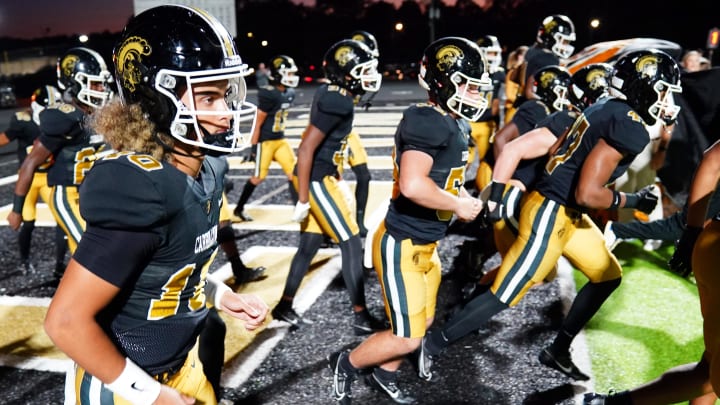 Oct 20, 2023; Carrollton, GA, USA; Carrollton Trojans quarterback Julian Lewis (10) enters the field against the Westlake Lions at Grisham Stadium. The 15-year-old Carrollton High student has already committed to playing for the University of Southern California Trojans and has been considered one of the top high school quarterback prospects. Mandatory Credit: John David Mercer-USA TODAY Sports