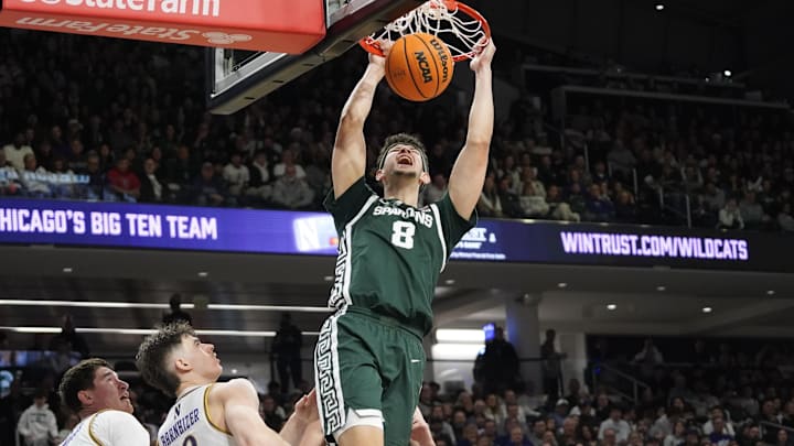 Jan 12, 2025; Evanston, Illinois, USA; Michigan State Spartans forward Frankie Fidler (8) dunks the ball on Northwestern Wildcats guard Brooks Barnhizer (13) during the first half at Welsh-Ryan Arena. Mandatory Credit: David Banks-Imagn Images