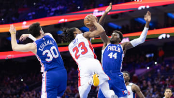 Jan 10, 2023; Philadelphia, Pennsylvania, USA; Detroit Pistons guard Jaden Ivey (23) drives for a shot between Philadelphia 76ers forward Paul Reed (44) and guard Furkan Korkmaz (30): Bill Streicher-USA TODAY Sports