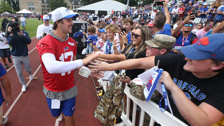 Bills quarterback Josh Allen runs around the practice field fence, high-fiving with fans following the final Buffalo Bills training camp session. Bills quarterback Josh Allen runs around the practice field fence, high-fiving with fans following the final Buffalo Bills training camp session.