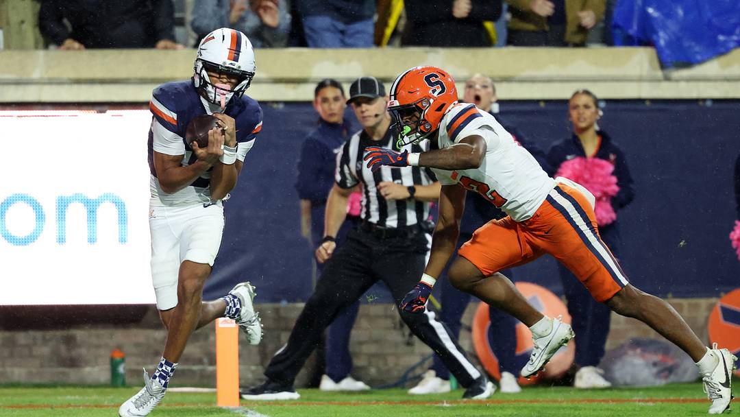 Oct 10, 2026; Charlottesville, Virginia, USA; Virginia Cavaliers wide receiver Da'shawn Martin (18) catches a touchdown pass as Syracuse Orange defensive back Chris Peal (12) defends in the third quarter at Scott Stadium. Mandatory Credit: Geoff Burke-Imagn Images