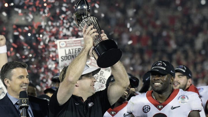 Jan 1, 2018; Pasadena, CA, USA; Georgia Bulldogs head coach Kirby Smart holds the Rose Bowl trophy on the podium after the Georgia Bulldogs defeated the Oklahoma Sooners in the 2018 Rose Bowl college football playoff semifinal game at Rose Bowl Stadium. Mandatory Credit: Kirby Lee-USA TODAY Sports