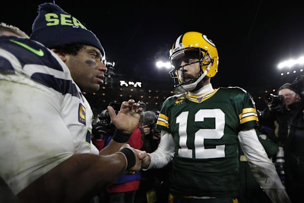Green Bay Packers quarterback Aaron Rodgers (12) greets Seattle Seahawks quarterback Russell Wilson (3)