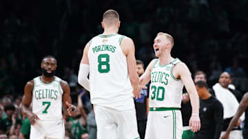 Jun 6, 2024; Boston, Massachusetts, USA; Boston Celtics center Kristaps Porzingis (8) reacts with forward Sam Hauser (30) in the first quarter against the Dallas Mavericks during game one of the 2024 NBA Finals at TD Garden. Mandatory Credit: David Butler II-Imagn Images