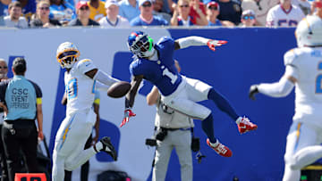 Sep 28, 2025; East Rutherford, New Jersey, USA; Los Angeles Chargers cornerback Cam Hart (20) breaks up a pass intended for New York Giants wide receiver Malik Nabers (1) during the second quarter at MetLife Stadium. Nabers was carted off the field with an injury after the play.  