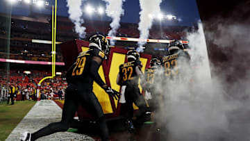 Aug 25, 2024; Landover, Maryland, USA; The Washington Commanders run onto field before playing against the New England Patriots during a preseason game at Commanders Field. Mandatory Credit: Peter Casey-Imagn Images