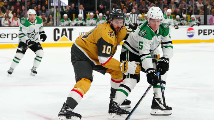 Apr 29, 2024; Las Vegas, Nevada, USA; Dallas Stars defenseman Nils Lundkvist (5) keeps the puck away from Vegas Golden Knights center Nicolas Roy (10) during the first period of game four of the first round of the 2024 Stanley Cup Playoffs at T-Mobile Arena. Mandatory Credit: Stephen R. Sylvanie-USA TODAY Sports