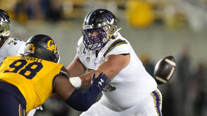 Ex-Husky offensive guard Jaxson Kirkland (51) is shown blocking California defensive end Nate Burrell (98) during their 2022 game in Berkeley.