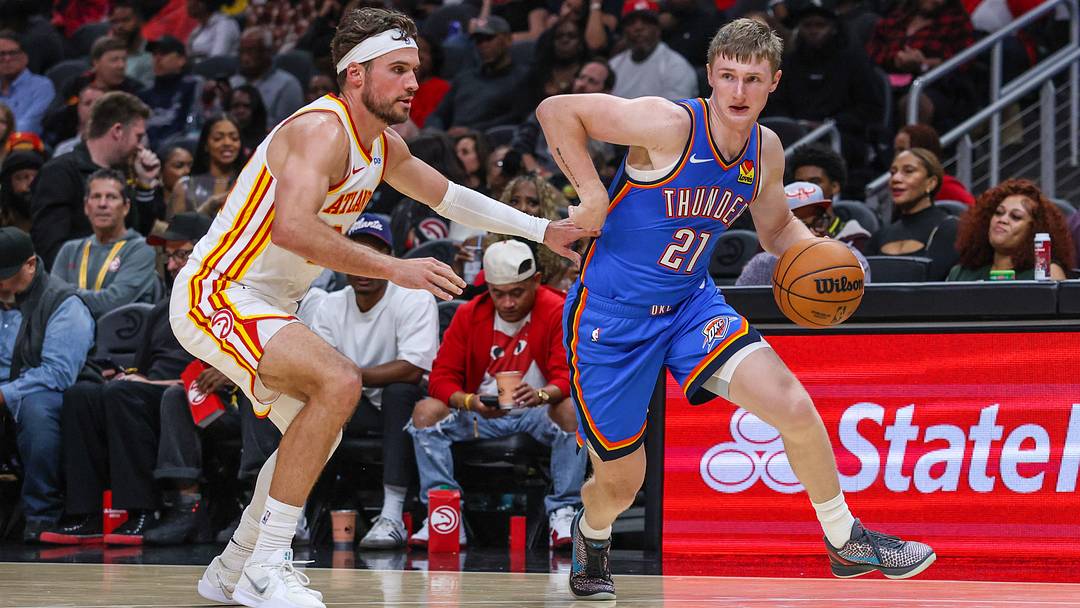 Oct 12, 2026; Atlanta, Georgia, USA; Oklahoma City Thunder guard Josh Dix (21) dribbles against Atlanta Hawks forward Corey Kispert (24) during the third quarter at State Farm Arena.