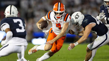 Sep 28, 2024; University Park, Pennsylvania, USA; Illinois Fighting Illini quarterback Luke Altmyer (9) runs while trying against Penn State Nittany Lions linebacker Tyler Elsdon (43) during the second quarter at Beaver Stadium. Mandatory Credit: Matthew O'Haren-Imagn Images