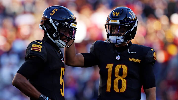 Oct 27, 2024; Landover, Maryland, USA; Washington Commanders quarterback Jayden Daniels (5) and quarterback Marcus Mariota (18) talk to each other during the first half against the Chicago Bears at Commanders Field. Mandatory Credit: Peter Casey-Imagn Images Oct 27, 2024; Landover, Maryland, USA; Washington Commanders quarterback Jayden Daniels (5) and quarterback Marcus Mariota (18) talk to each other during the first half against the Chicago Bears at Commanders Field. Mandatory Credit: Peter Casey-Imagn Images