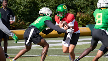 Oregon quarterback Dillon Gabriel carries the ball during practice with the Oregon Ducks Tuesday, Aug. 20, 2024 at the Hatfield-Dowlin Complex in Eugene, Ore.