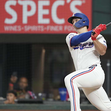 Sep 7, 2024; Arlington, Texas, USA; Texas Rangers center fielder Wyatt Langford (36) follows through on a RBI double against the Los Angeles Angels during the eighth inning at Globe Life Field. Mandatory Credit: Jim Cowsert-Imagn Images