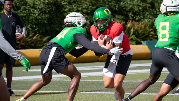 Oregon quarterback Dillon Gabriel carries the ball during practice with the Oregon Ducks Tuesday, Aug. 20, 2024 at the Hatfield-Dowlin Complex in Eugene, Ore.