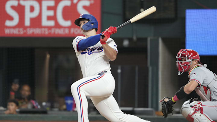 Sep 7, 2024; Arlington, Texas, USA; Texas Rangers center fielder Wyatt Langford (36) follows through on a RBI double against the Los Angeles Angels during the eighth inning at Globe Life Field. Mandatory Credit: Jim Cowsert-Imagn Images