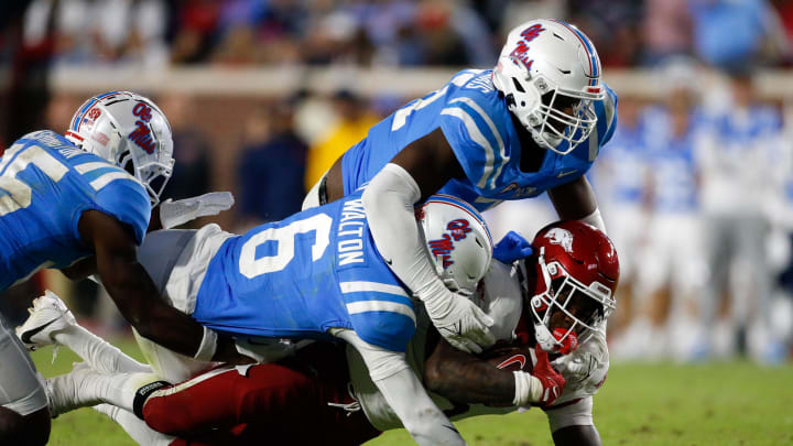 Oct 7, 2023; Oxford, Mississippi, USA; Mississippi Rebels defensive back Zamari Walton (6) and defensive linemen Zxavian Harris (51) tackle Arkansas Razorbacks running back Rashod Dubinion (7) during the second half at Vaught-Hemingway Stadium. Mandatory Credit: Petre Thomas-USA TODAY Sports