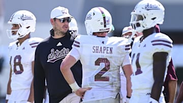 Sep 21, 2024; Starkville, Mississippi, USA; Mississippi State Bulldogs head coach Jeff Lebby speaks with quarterback Blake Shapen (2) during the fourth quarter against the Florida Gators at Davis Wade Stadium at Scott Field. Mandatory Credit: Matt Bush-Imagn Images
