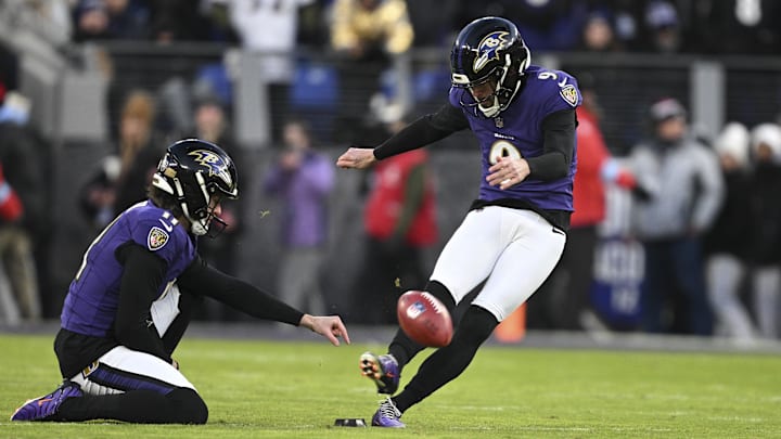 Jan 4, 2025; Baltimore, Maryland, USA;  Baltimore Ravens place kicker Justin Tucker (9) kicks off as  punter Jordan Stout (11) holds during the first quarter against the Cleveland Browns at M&T Bank Stadium. Mandatory Credit: Tommy Gilligan-Imagn Images