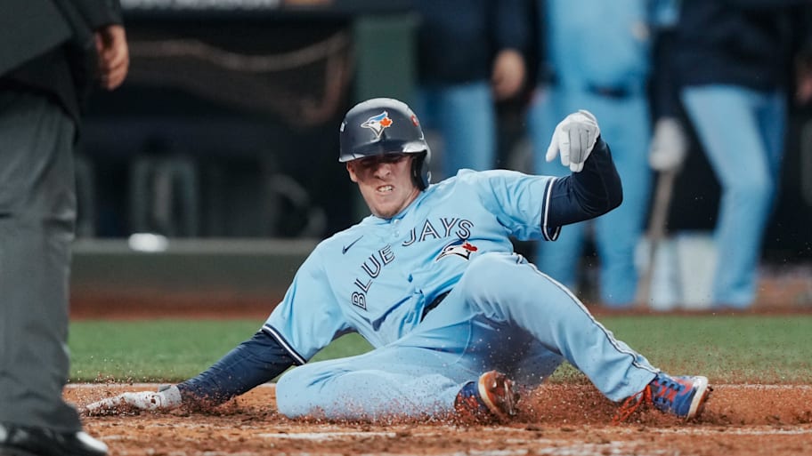 Toronto Blue Jays pinch runner Myles Straw (3) slides safely into home plate.