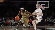 Nov 14, 2025; Athens, Georgia, USA; Georgia Tech Yellow Jackets guard Akai Fleming (0) dribbles past Georgia Bulldogs guard Blue Cain (0) during the second half at Stegeman Coliseum. Mandatory Credit: Mady Mertens-Imagn Images