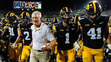 Iowa Hawkeyes head coach Kirk Ferentz runs off the field with his players after becoming the winningest coach in Big Ten history, passing Woody Hayes, with a win over the Massachusetts Minutemen Sept. 13, 2025 at Kinnick Stadium in Iowa City, Iowa.