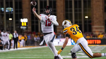Sep 2, 2023; Laramie, Wyoming, USA; Texas Tech Red Raiders quarterback Tyler Shough (12) throws for a touchdown in double overtime against the Wyoming Cowboys at Jonah Field at War Memorial Stadium. Mandatory Credit: Troy Babbitt-USA TODAY Sports