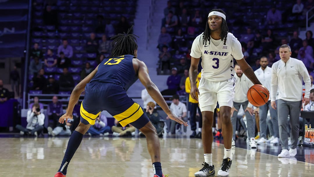 Mar 3, 2026; Manhattan, Kansas, USA; Kansas State Wildcats guard C.J. Jones (3) dribbles against West Virginia Mountaineers guard Chance Moore (13) during the second half at Bramlage Coliseum. 