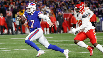 Buffalo Bills quarterback Josh Allen (17) sprints away from Kansas City Chiefs defensive end Neil Farrell (92) for some of his 72 yards.