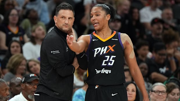 A photo of Alyssa Thomas having a discussion with head coach Nate Tibbetts. 