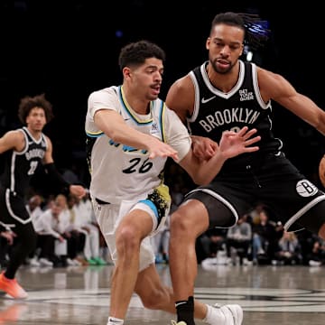 Jan 6, 2025; Brooklyn, New York, USA; Indiana Pacers guard Ben Sheppard (26) fights for the ball against Brooklyn Nets forward Tosan Evbuomwan (12) during the third quarter at Barclays Center. Mandatory Credit: Brad Penner-Imagn Images