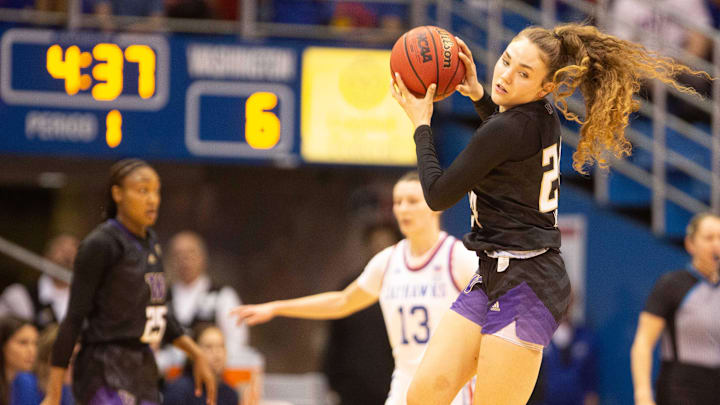 Washington freshman guard Elle Ladine (24) catches a pass in the first quarter of Wednesday's WNIT semifinal game against Kansas inside Allen Fieldhouse.