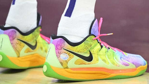 Kevin Durant wears green and orange Nike sneakers.
