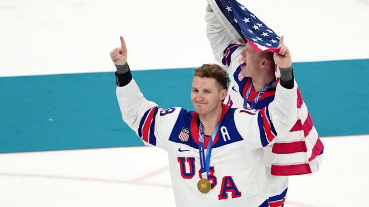 Feb 22, 2026; Milan, Italy; Brady Tkachuk and Matthew Tkachuk of the United States celebrate after winning the men's ice hockey gold medal game during the Milano Cortina 2026 Olympic Winter Games at Milano Santagiulia Ice Hockey Arena. Mandatory Credit: James Lang-Imagn Images