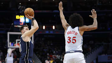 Dec 5, 2024; Washington, District of Columbia, USA; Dallas Mavericks guard Luka Doncic (77) shoots the ball as Washington Wizards forward Marvin Bagley III (35) defends in the first quarter at Capital One Arena. Mandatory Credit: Geoff Burke-Imagn Images