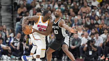 Nov 23, 2024; San Antonio, Texas, USA;  Golden State Warriors forward Draymond Green (23) looks to pass in front of San Antonio Spurs forward Harrison Barnes (40) in the second half at Frost Bank Center. 
