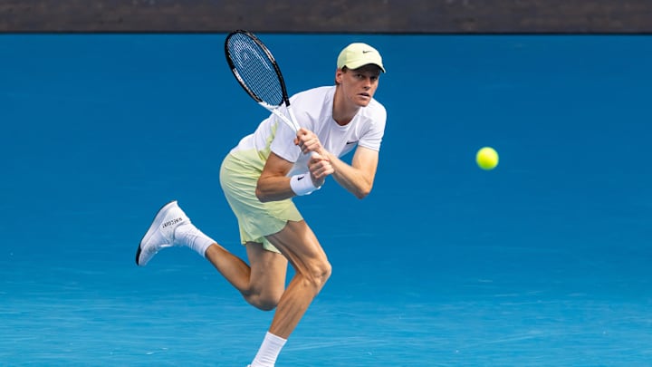 Jan 20, 2025; Melbourne, Victoria, Australia; Jannik Sinner of Italy plays a backhand during his match against Holger Rune of Denmark in the fourth round of the men's singles at the 2025 Australian Open at Melbourne Park. Mandatory Credit: Mike Frey-Imagn Images
