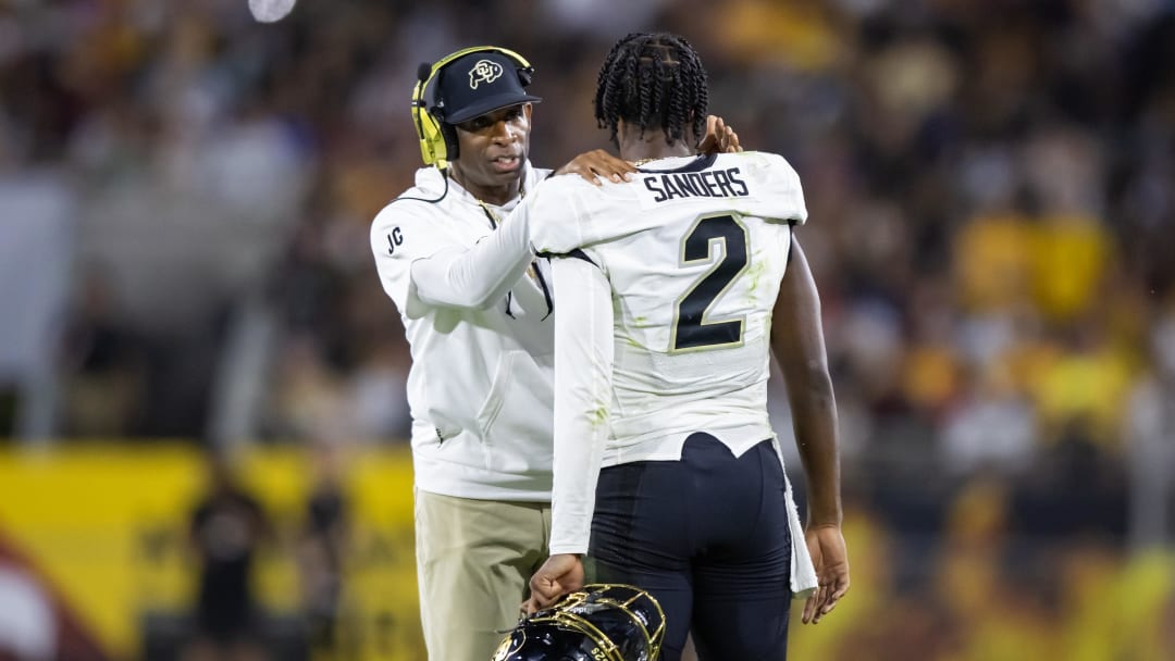 Oct 7, 2023; Tempe, Arizona, USA; Colorado Buffaloes head coach Deion Sanders with son and quarterback Shedeur Sanders (2) against the Arizona State Sun Devils at Mountain America Stadium. Mandatory Credit: Mark J. Rebilas-USA TODAY Sports