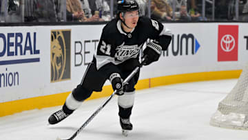 Apr 23, 2025; Los Angeles, California, USA; Los Angeles Kings defenseman Jordan Spence (21) handles the puck during game 2 of the 2025 Stanley Cup Playoffs against the Edmonton Oilers at Crypto.com Arena. Mandatory Credit: Jayne Kamin-Oncea-Imagn Images