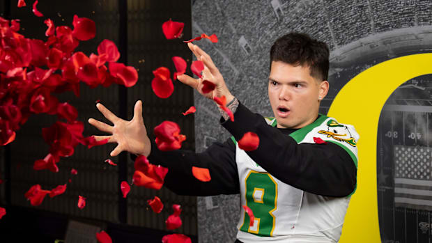 Oregon quarterback Dillon Gabriel throws a handful of rose petals during a video at media day for the Oregon Ducks in Los Ang