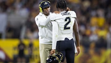 Colorado Buffaloes head coach Deion Sanders with son and quarterback Shedeur Sanders (2) against the Arizona State Sun Devils at Mountain America Stadium.