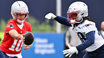 Jun 9, 2025; Foxborough, MA, USA; New England Patriots quarterback Drake Maye (10) hands the ball to running back Rhamondre Stevenson (38) during minicamp at Gillette Stadium. Mandatory Credit: Eric Canha-Imagn Images