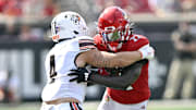 Sep 20, 2025; Louisville, Kentucky, USA;  Louisville Cardinals running back Keyjuan Brown (22) runs the ball against Bowling Green Falcons linebacker Gideon Lampron (4) during the first quarter at L&N Federal Credit Union Stadium. Mandatory Credit: Jamie Rhodes-Imagn Images