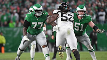 Nov 3, 2024; Philadelphia, Pennsylvania, USA; Philadelphia Eagles offensive tackle Mekhi Becton (77) and center Cam Jurgens (51) block Jacksonville Jaguars defensive tackle DaVon Hamilton (52) at Lincoln Financial Field. Mandatory Credit: Eric Hartline-Imagn Images
