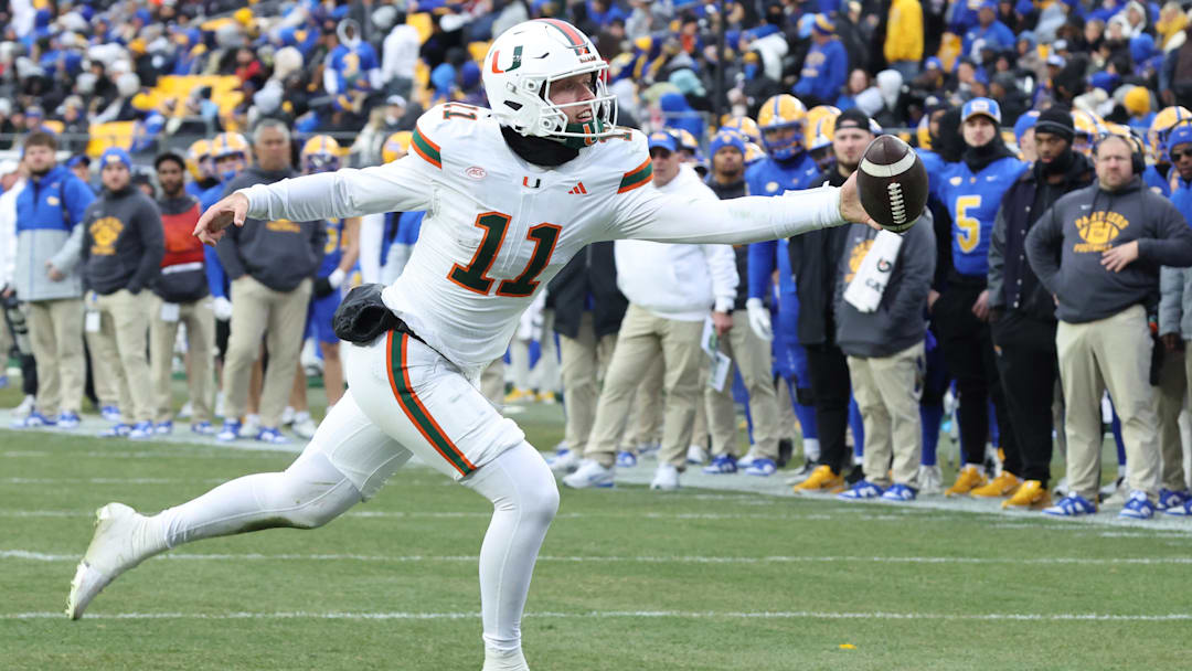 Nov 29, 2025; Pittsburgh, Pennsylvania, USA;  Miami Hurricanes quarterback Carson Beck (11) reaches for an errant pass on a trick play against the Pittsburgh Panthers.