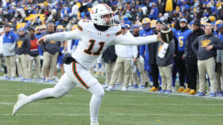 Nov 29, 2025; Pittsburgh, Pennsylvania, USA;  Miami Hurricanes quarterback Carson Beck (11) reaches for an errant pass on a trick play against the Pittsburgh Panthers.