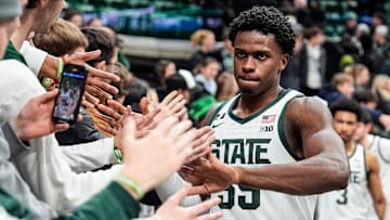 Michigan State forward Coen Carr (55) high-fives student fans after 73-51 win over Minnesota at Breslin Center in East Lansing on Tuesday, Jan. 28, 2025.