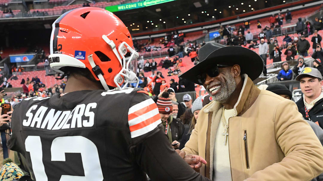 Dec 28, 2025; Cleveland, Ohio, USA; Cleveland Browns quarterback Shedeur Sanders (12) and his father Deion Sanders on the sideline before the game against the Pittsburgh Steelers at Huntington Bank Field. 